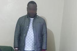 Photo of suspect arrested with stolen phones and laptops in Nairobi.